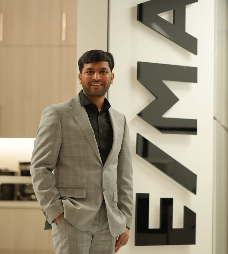 Kaushik Patel standing beside the RE/MAX sign